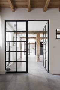 Internal door leading to room with timber beams