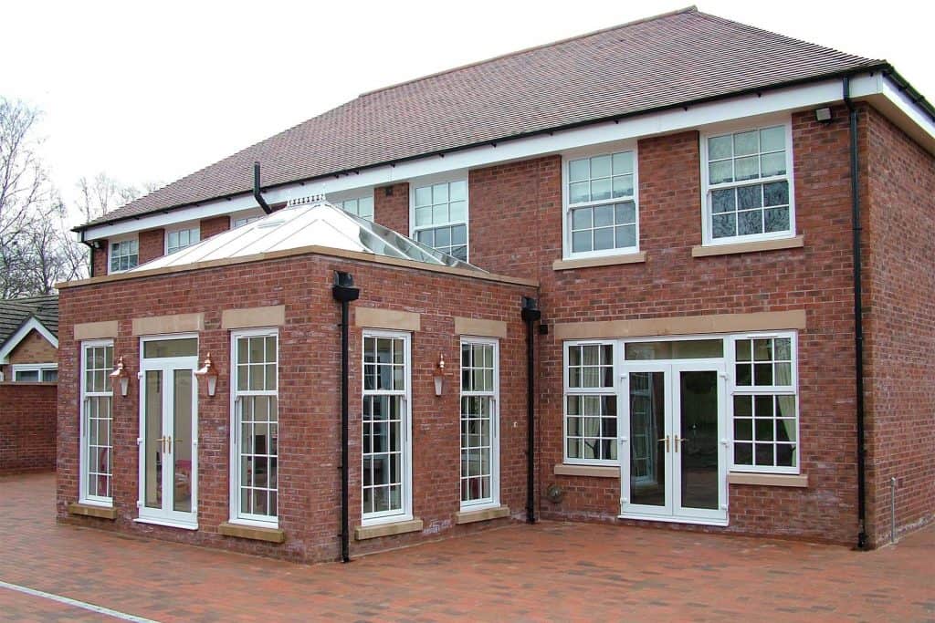 Aluminium vertical sliding sash windows in a modern brick house.
