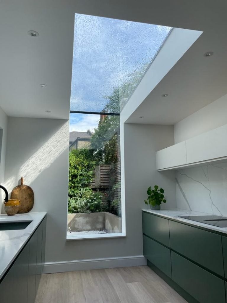 Glass box extension with skylight for natural light.